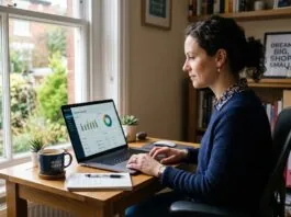 UK small business owner reviewing free accounting software dashboard on a laptop at a home office desk